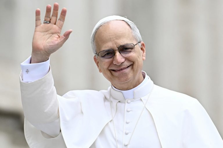 Pope Leo XIV waves to the crowd during the weekly general audience at St Peter's Square in The Vatican on May 21, 2025. (Photo by Filippo MONTEFORTE / AFP)